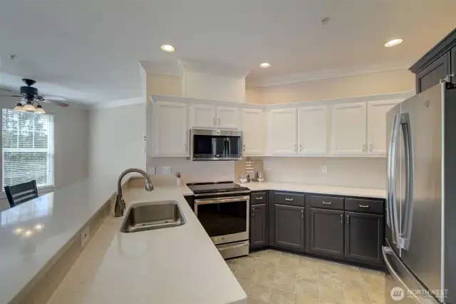 You'll appreciate the ample cabinetry and a peninsula with eating bar.