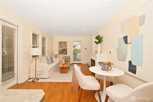 View of main living, dining and French doors on the left leading to one of two private patios.