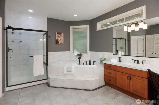 The primary 5-piece bathroom offers dual closets, jetted soaking tub, & dual vanity.