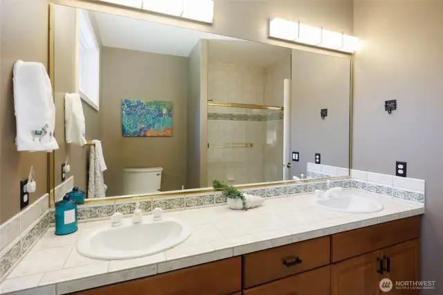 Full hall bathroom with a dual vanity.