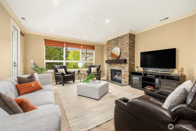 The large living room with stone surround gas fireplace