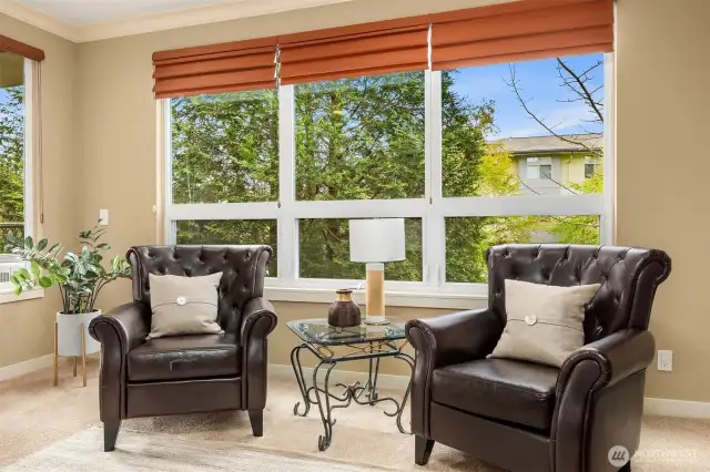 Large bay windows bathe the room in sunlight