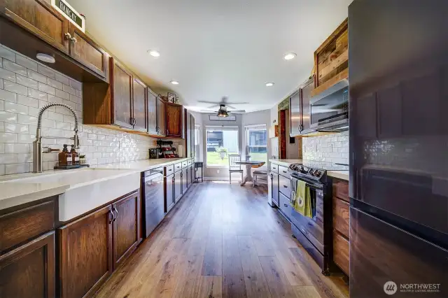 Beautiful white quartz countertops and subway tile have been added, new light fixture, new sink, and new appliances giving this kitchen a beautiful face lift.