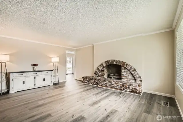The living room showcases a custom wood-burning fireplace with a hearth.