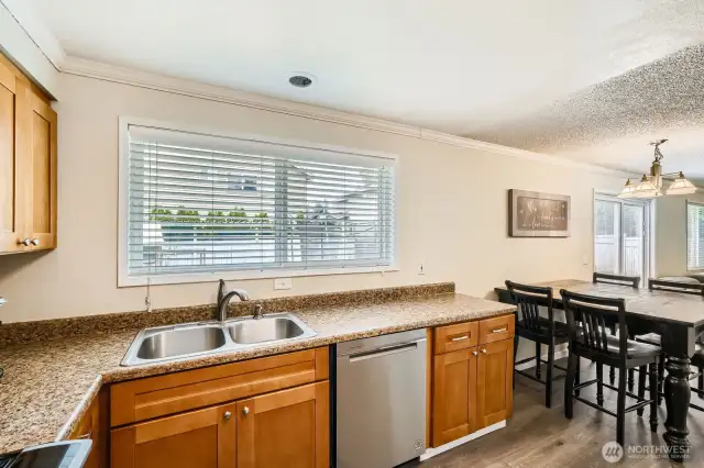 A window in the kitchen lets in more added light.
