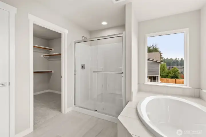 Primary bath comes standard with a separate walk-in shower with glass doors.
