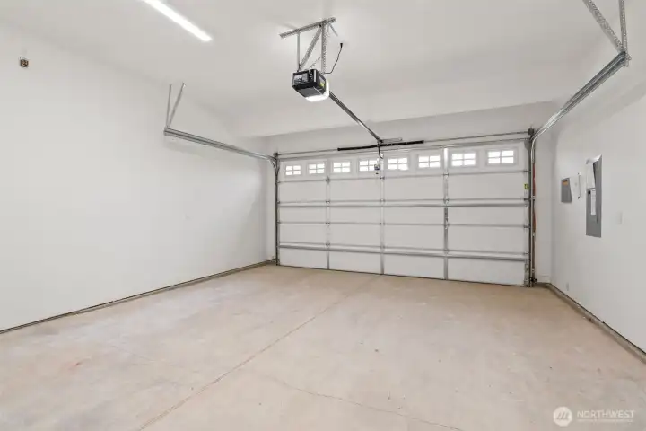 Double car garage is drywalled and includes standard garage door opener.