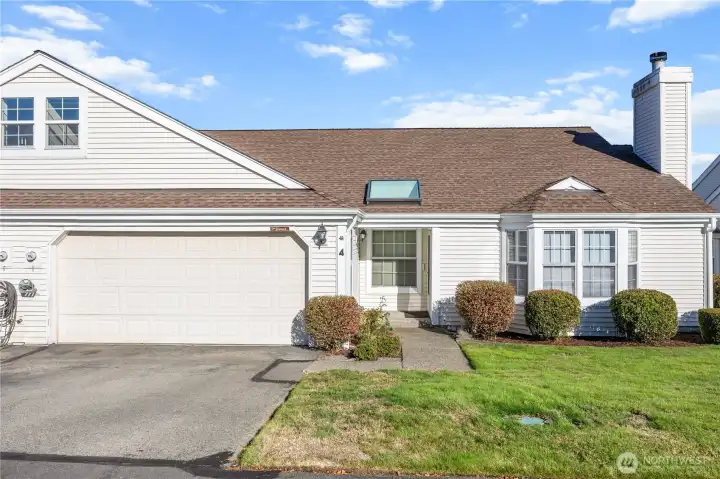 A duplex style condo with fenced yard & 2 car garage