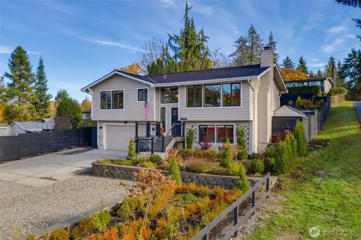 Front view of home, driveway and garden spaces