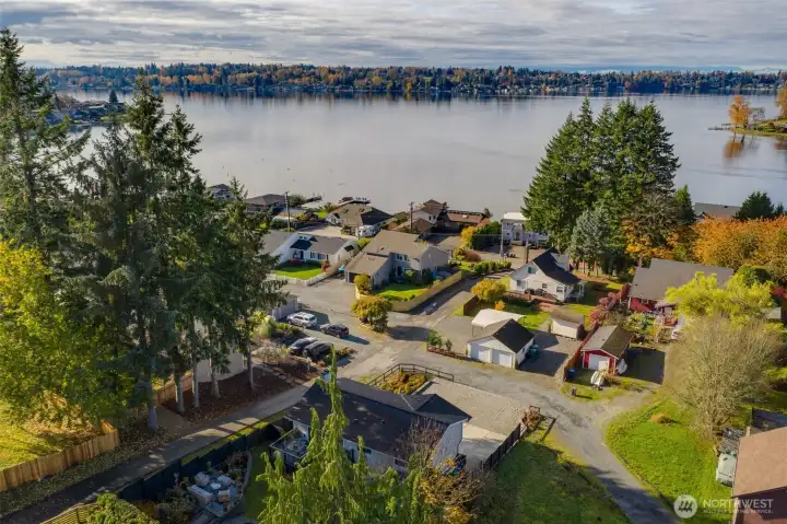 View of the home and lake from behind the property