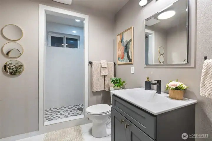 Downstairs bathroom remodel includes full height tile shower, new lighting/plumbing fixtures, new vanity and flooring