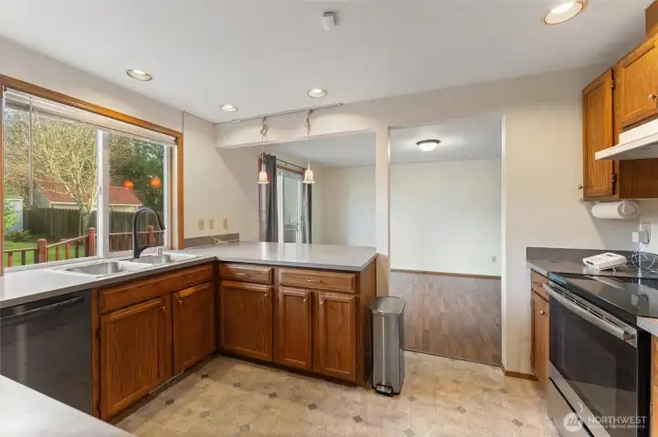 Open-concept kitchen with wraparound counters, pendant lighting, and sightlines into the dining area — great for cooking while staying connected to guests.
