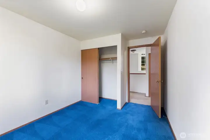 Cozy bedroom featuring bright natural light, a convenient closet, and fresh carpet — ideal as a guest room, home office, or kids’ room.