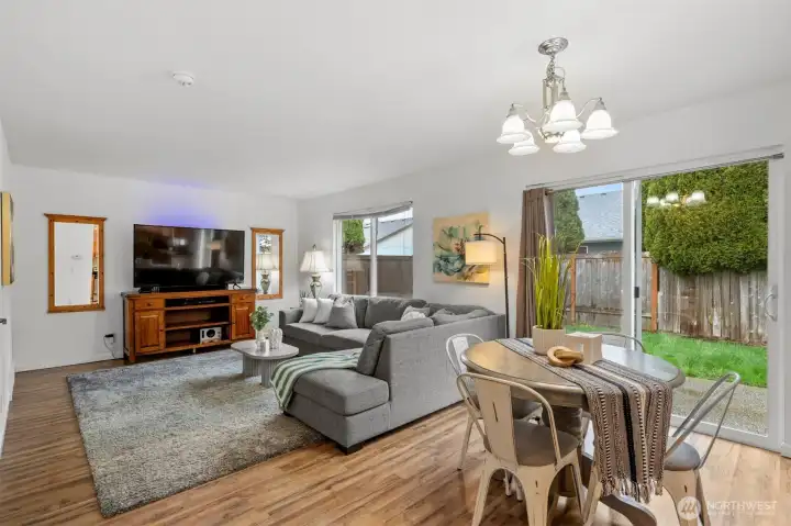 Living room off the kitchen has access to the back yard, garage and powder bath.