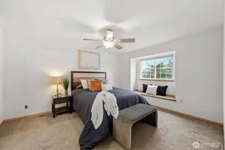 Spacious primary suite has a great window seat!