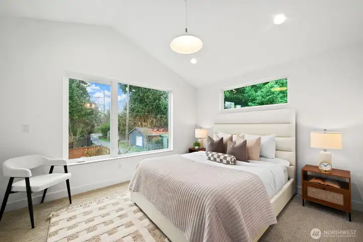 The primary has vaulted ceilings, large closet, and spa-like en suite bathroom.