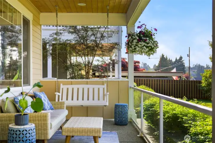Covered front porch with hanging swing — Pacific Northwest indoor-outdoor living at its finest in North Tacoma's 98407. Covered front porch with hanging swing — Pacific Northwest indoor-outdoor living at its finest in North Tacoma's 98407.