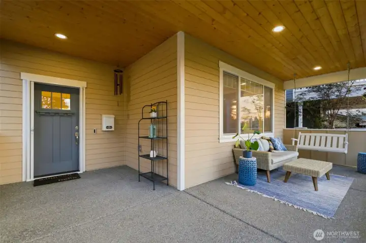 Charming craftsman front entry with cedar T&G ceiling, classic three-light door, and welcoming porch swing. Charming craftsman front entry with cedar T&G ceiling, classic three-light door, and welcoming porch swing.
