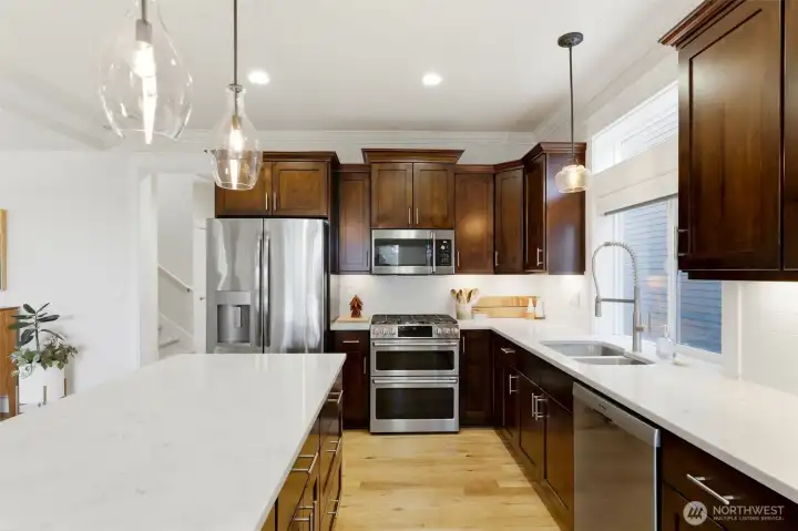 Gas range with double oven, Bosch dishwasher, and full subway-tile backsplash — built for cooks who entertain. Gas range with double oven, Bosch dishwasher, and full subway-tile backsplash — built for cooks who entertain.