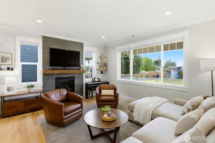 Open-concept great room anchored by a floor-to-ceiling stacked-stone gas fireplace with reclaimed wood mantel — true entertainer's layout. Open-concept great room anchored by a floor-to-ceiling stacked-stone gas fireplace with reclaimed wood mantel — true entertainer's layout.