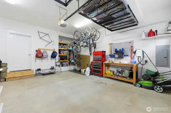 Attached garage with Level 2 EV charger, overhead storage racks, and built-in workbench — every Northwest buyer's wish list. Attached garage with Level 2 EV charger, overhead storage racks, and built-in workbench — every Northwest buyer's wish list.