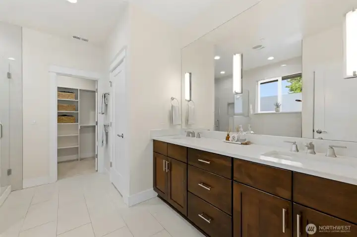 Spa-style primary en-suite with double quartz vanity, walk-in closet, and oversized glass shower. Spa-style primary en-suite with double quartz vanity, walk-in closet, and oversized glass shower.