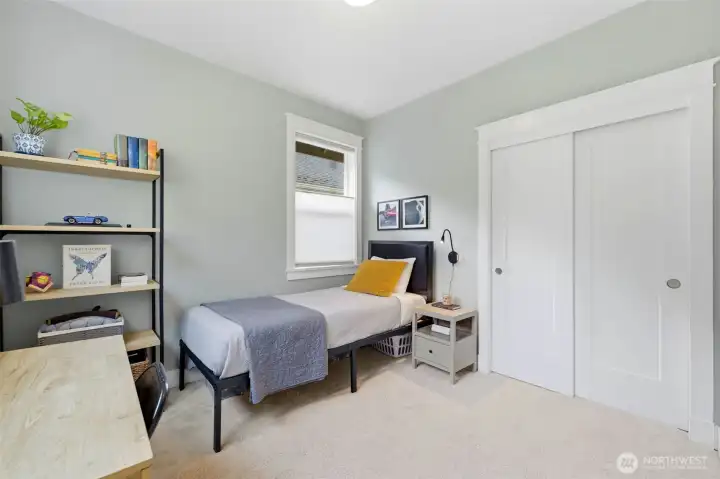 Third bedroom with ample closet space and warm natural light — all four bedrooms conveniently upstairs. Third bedroom with ample closet space and warm natural light — all four bedrooms conveniently upstairs.