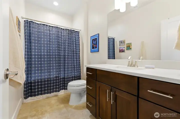 Full guest bath with quartz counters, alder cabinetry, and tub/shower combo — upstairs convenience for all four bedrooms. Full guest bath with quartz counters, alder cabinetry, and tub/shower combo — upstairs convenience for all four bedrooms.
