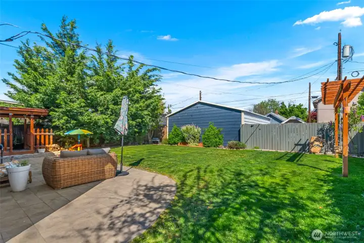 Large, flat fenced yard.. garage in the back ground. Dog run to the left.