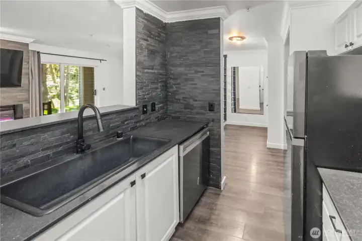Upgraded sink/faucet (under sink water filter), quartz countertops, tiled backsplash. Stainless steel appliances stay.