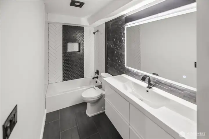 tiled walls and flooring, upgraded ceramic sink, faucets and other hardware