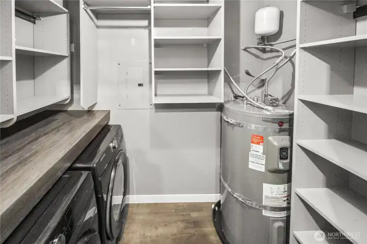 Utility room. newer washer and dryer stay. Plenty of shelving/storage space