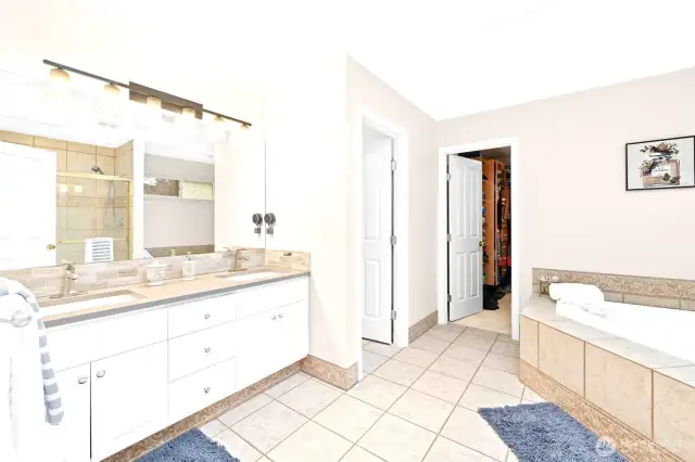 Primary bath with custom built in closet, WC, & soaking tub