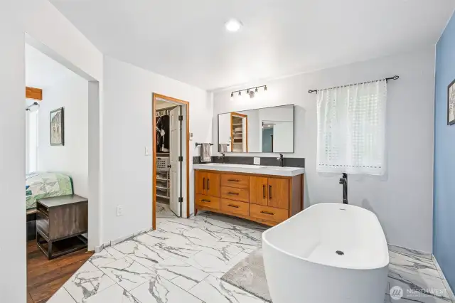 Recently updated bathroom with dual vanity and porcelain tile.