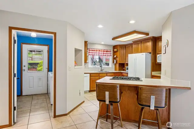 Enjoy breakfast at the breakfast bar. Laundry room to the left and back door leads you out to the back deck.