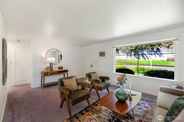 Living room with picture window looking out at Discovery Park across the street