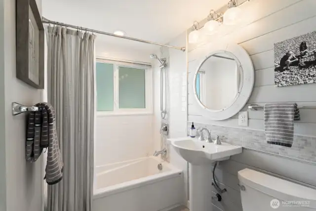 Kohler fixtures and a sunny full bath with tons of built in storage.