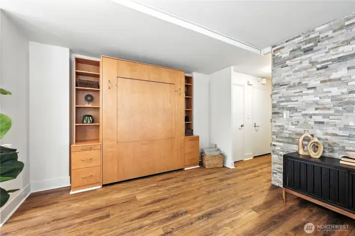 Custom Murphy bed with built-in shelves & drawers for additional storage.