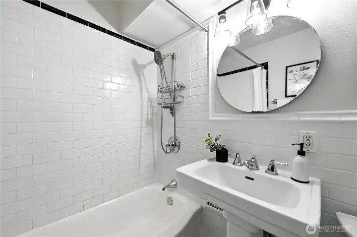 Pretty white tile bath with charming pedestal sink!