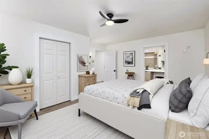 Large primary bedroom with ceiling fan for extra comfort, connects to the primary bath. Virtually staged.