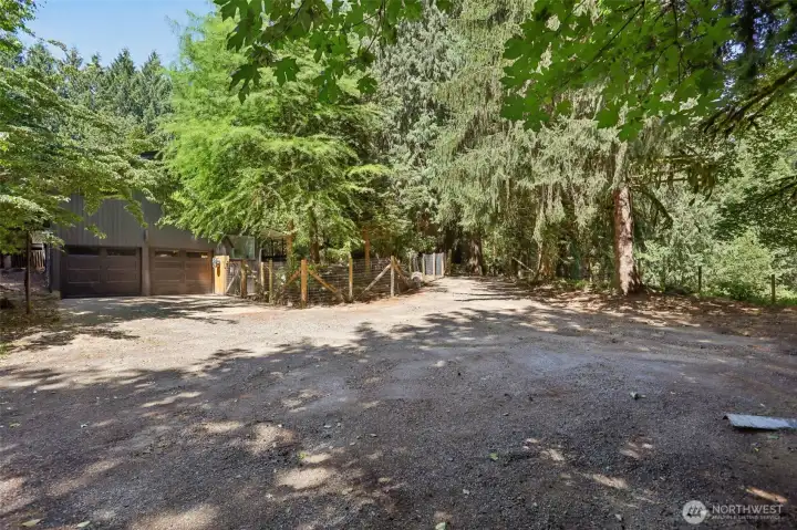 This is the west view after you walk down the stairs showing the fenced area, attached to the house and goes around the shop area....for pets?