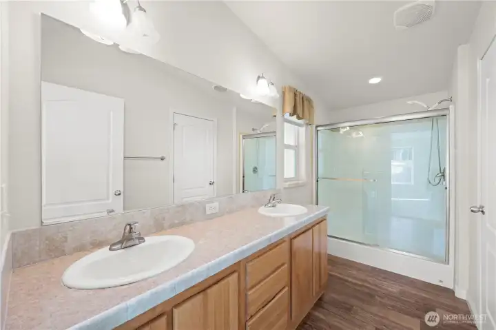 Spacious and well-designed, the master bathroom features double sinks, a walk-in shower, and plenty of storage to keep everything organized and accessible.