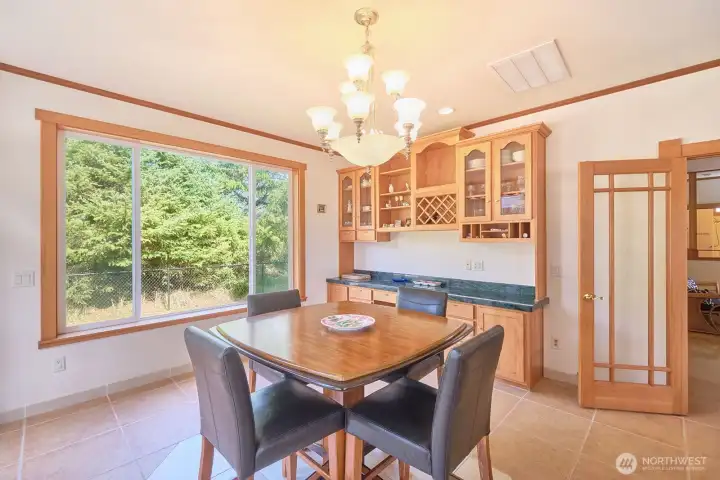 Bright and airy dining area has built-in cabinetry