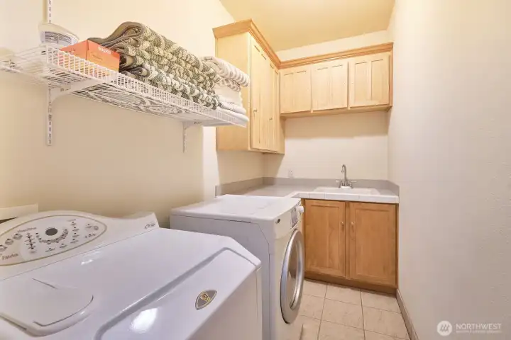Laundry room with sink and storage