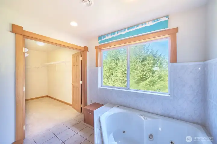 Well-appointed primary bathroom with soaking tub