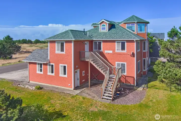 East side of house featuring exterior staircase and secondary entrance access