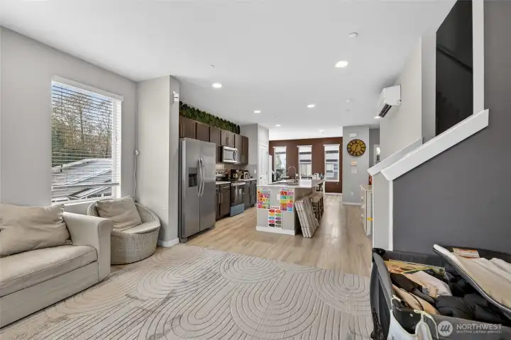 Seamless open-concept floor plan elegantly connecting the living, dining, and kitchen areas