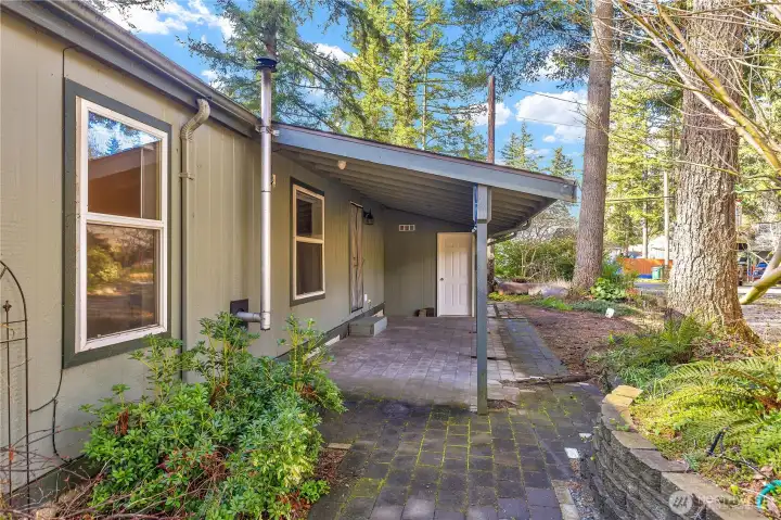 Step out to the covered porch and garden shed
