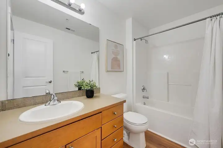Refreshed full bathroom on the upper level features crisp new paint, a modern light fixture, and a clean, contemporary design throughout. A spacious vanity, bright lighting, and a well-appointed tub/shower combo make this an inviting and functional space for everyday use.