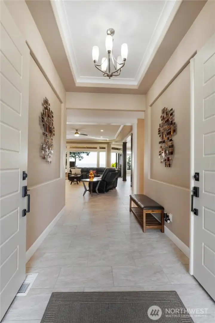 Enter through double doors into one level living featuring 9-11 foot ceilings, 2 ensuites + additional bedroom and theater/office room, heated floor, stunning views and open concept living